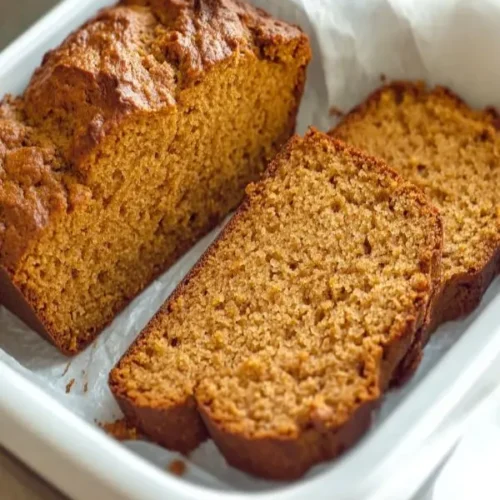 Best Pumpkin Bread & Fall Baking Recipes 6 Homemade pumpkin bread cooling on kitchen counter with visible moist crumb texture
