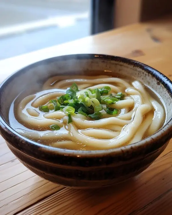 Japanese and Asian Comfort Food Recipes 2 Bowl of creamy miso udon noodles with thick wheat noodles in rich broth topped with green on